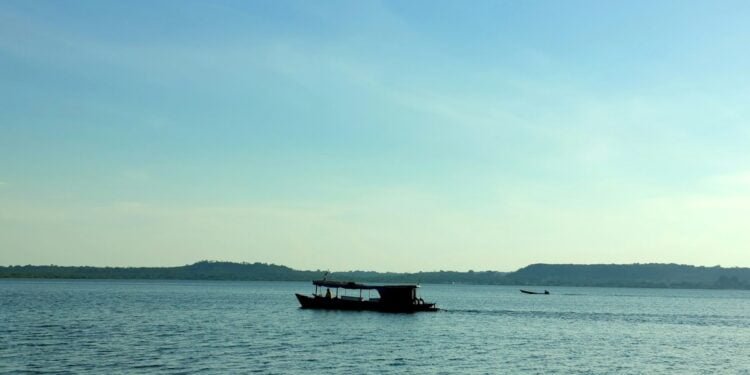 black boat on sea under blue sky during daytime