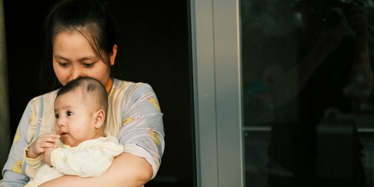 a woman holding a baby in her arms