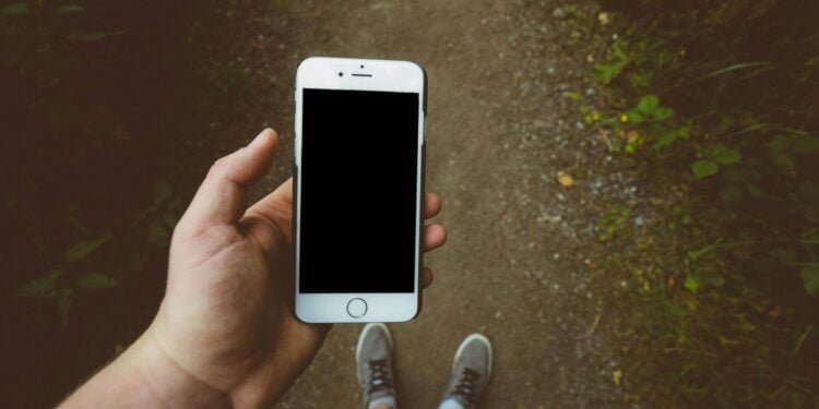 person holding silver iPhone 6 with black case