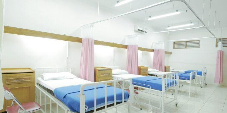 empty hospital bed inside room